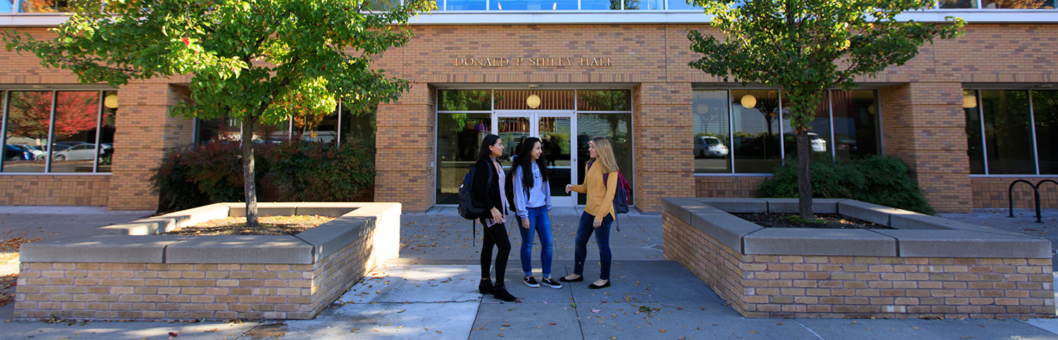 Three students standing outside of Shiley Hall.