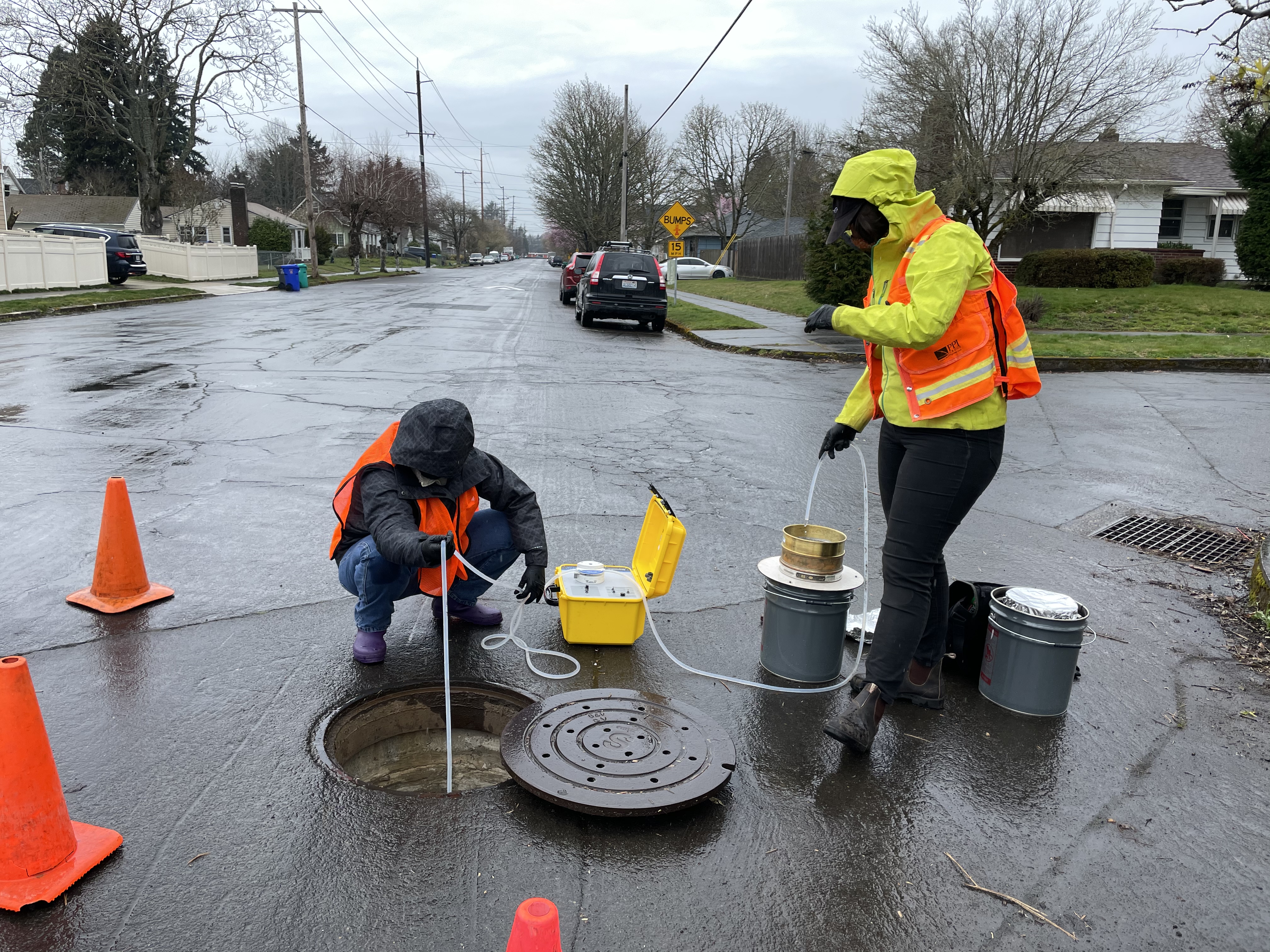 CE students taking stormwater sample in neighborhood