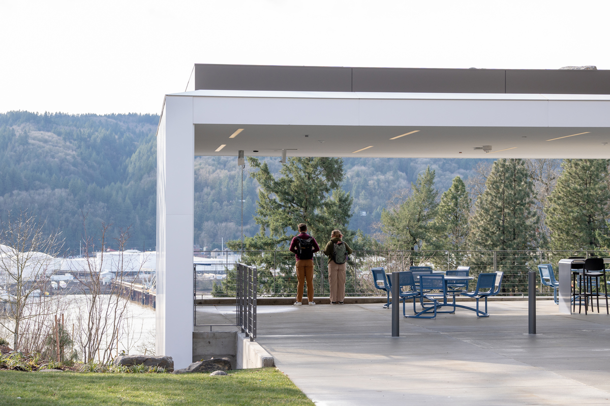The outdoor patio of Shiley with students overlooking the river