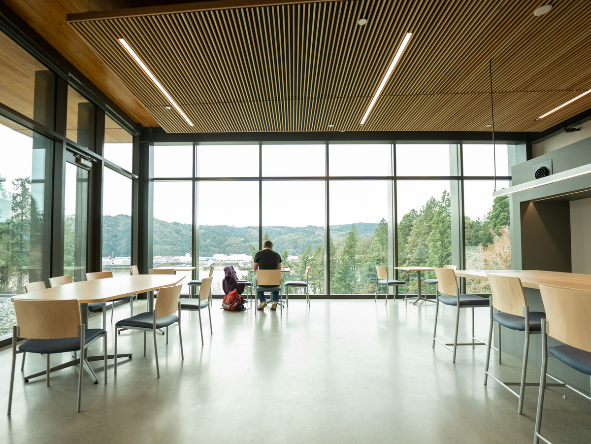 A river view lounge with a wall of floor to ceiling windows in the Shiley Marcos Center