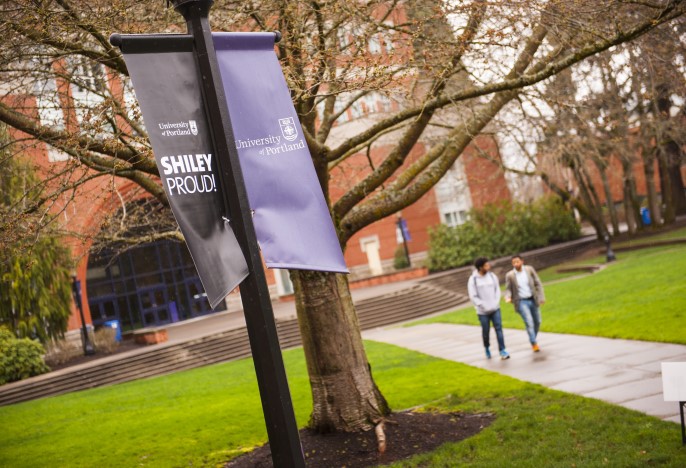 A banner on a lamp post displaying Shiley Hall